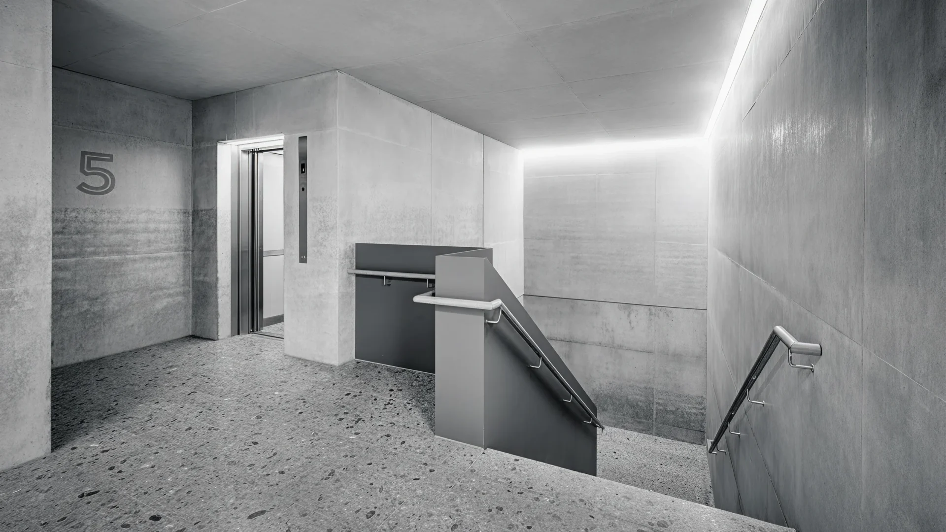 Moderner Aufzug im minimalistischen Treppenhaus mit Betonoptik